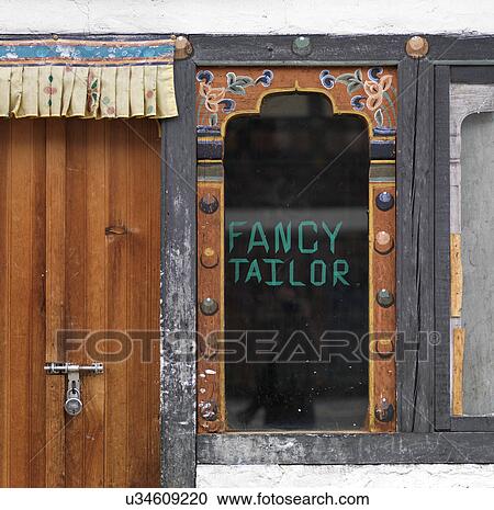 Stock Image - Closed door of a tailor workshop, Paro Valley, Paro District, Bhutan. Fotosearch