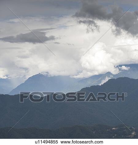 Stock Photography - Clouds over mountain region Bhutan, Thimphu, Timphu District. Fotosearch