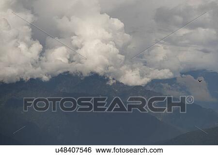Stock Photograph - Clouds over mountains, Dochula Pass, Thimphu District, Bhutan. Fotosearch