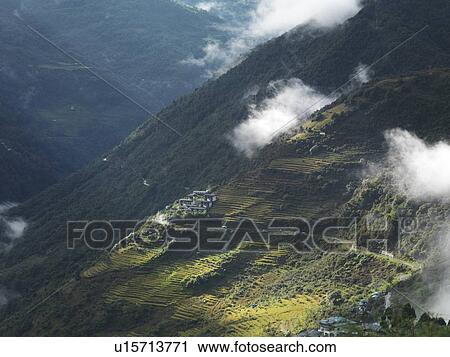 Stock Image - Clouds over mountains, Trongsa District, Bhutan. Fotosearch