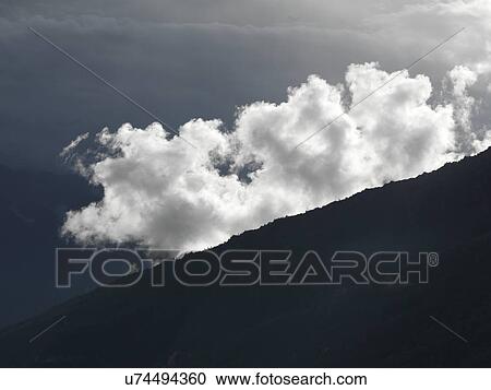 Stock Image - Clouds over mountains, Trongsa District, Bhutan. Fotosearch