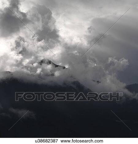 Stock Photo - Clouds over mountains, Trongsa District, Bhutan. Fotosearch