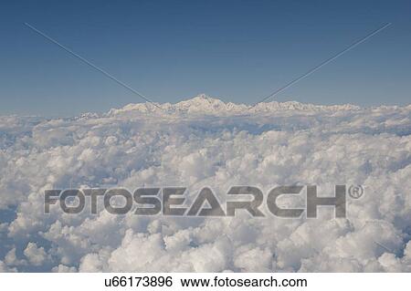 Stock Photograph - Clouds with Mount Everest in the background, Himalayas, Nepal. Fotosearch