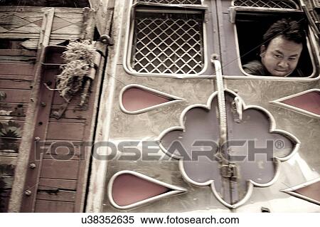 Driver looking out a window of semi-truck, Bhutan View Large Photo Image Stock Photography - Driver looking out a window of semi-truck, Bhutan. Fotosearch