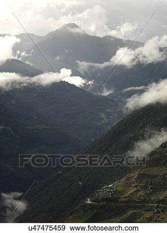 Fog over mountain range, Trongsa District, Bhutan View Large Photo Image Stock Photo - Fog over mountain range, Trongsa District, Bhutan. Fotosearch