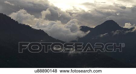 Fog over mountain range, Trongsa District, Bhutan View Large Photo Image Stock Photo - Fog over mountain range, Trongsa District, Bhutan. Fotosearch