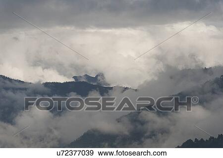 Fog over mountains, Chokhor Valley, Bumthang District, Bhutan View Large Photo Image Stock Photo - Fog over mountains, Chokhor Valley, Bumthang District, Bhutan. Fotosearch