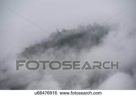 Stock Photograph - Fog over mountains, Punakha Valley, Punakha District, Bhutan. Fotosearch