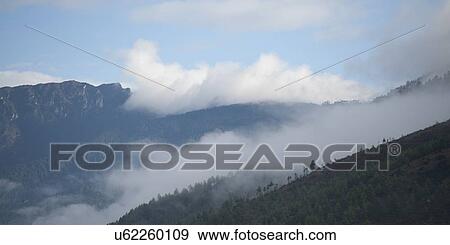 Stock Photo - Fog over mountains, Thimphu, Bhutan. Fotosearch