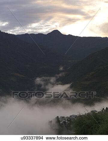 Picture - Fog over town, Trongsa District, Bhutan. Fotosearch