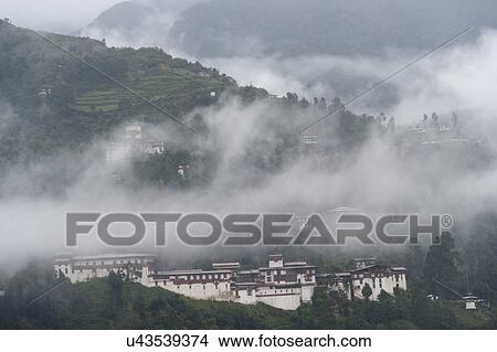 Picture - Fog over Trongsa Dzong, Trongsa, Bhutan. Fotosearch