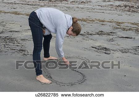 Girl drawing heart in sand on beach, Shallow Bay, Gros Morne National Park, Newfoundland and Labrador, Canada View Large Photo Image Stock Photography - Girl drawing heart in sand on beach, Shallow Bay, Gros Morne National Park, Newfoundland and Labrador, Canada. Fotosearch