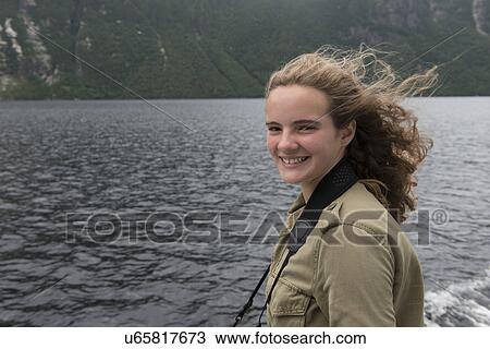 Stock Image - Girl enjoying Western Brook Pond fjord boat tour, Gros Morne National Park, Newfoundland and Labrador, Canada. Fotosearch