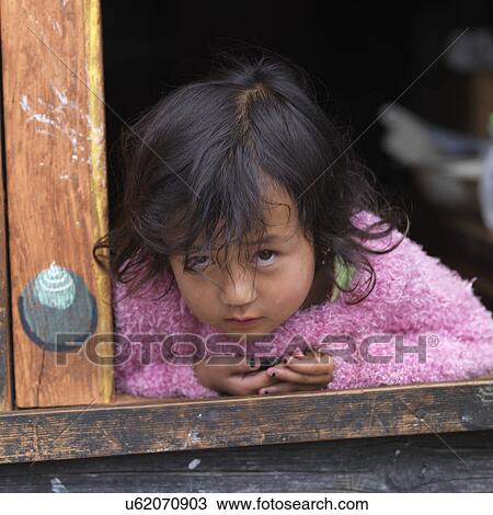 Girl leaning against a window, Paro Valley, Paro District, Bhutan View Large Photo Image Stock Image - Girl leaning against a window, Paro Valley, Paro District, Bhutan. Fotosearch