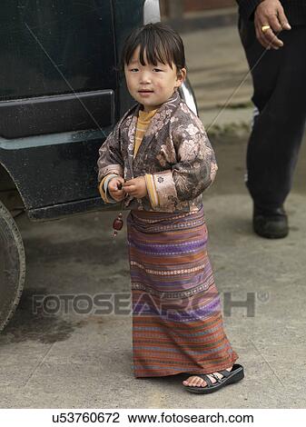 Stock Image - Girl standing on the road, Chokhor Town, Bumthang District, Bhutan. Fotosearch