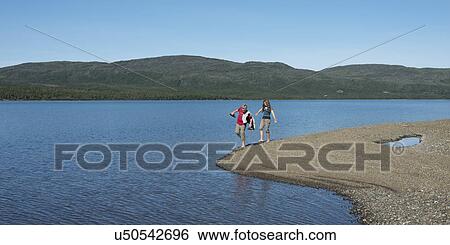 Girls walking on the beach, Trout River Pond, Gros Morne National Park, Newfoundland and Labrador, Canada View Large Photo Image Stock Photograph - Girls walking on the beach, Trout River Pond, Gros Morne National Park, Newfoundland and Labrador, Canada. Fotosearch