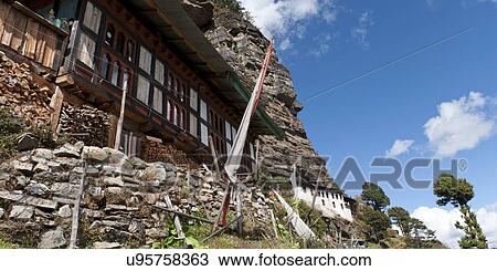 Stock Image - House on a mountain, Bhutan. Fotosearch