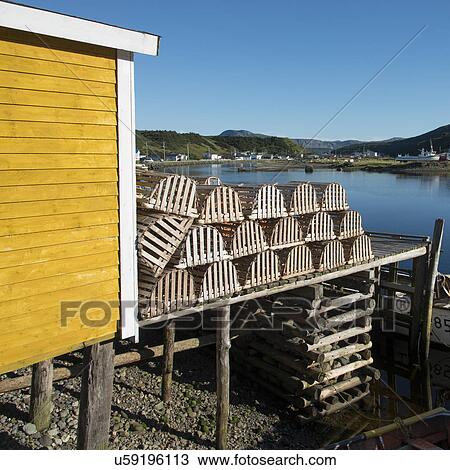 Stock Image - Lobster traps at fishing dock, Trout River, Southeast Brook Falls, Gros Morne National Park, Newfoundland and Labrador, Canada. Fotosearch