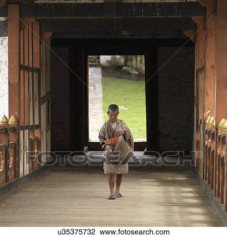 Stock Image - Man at Punakha Monastery, Punakha, Bhutan. Fotosearch