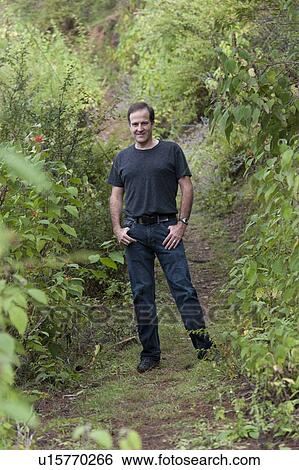 Stock Photograph - Man in a forest, Paro Valley, Paro District, Bhutan. Fotosearch