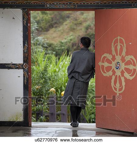 Man standing in doorway Bhutan, Trongsa District, Yangkhil Resort View Large Photo Image Stock Photograph - Man standing in doorway Bhutan, Trongsa District, Yangkhil Resort. Fotosearch