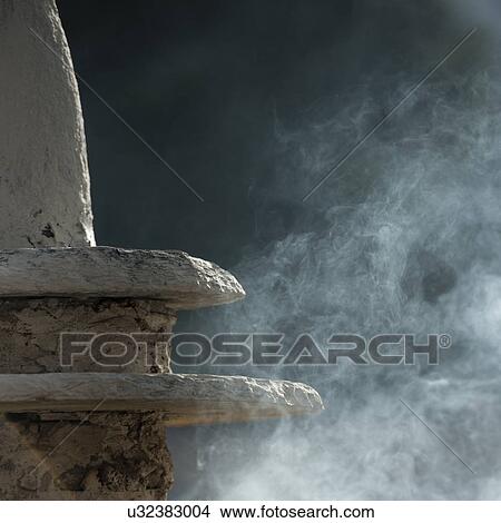 Picture - Mist of incense at the National Memorial Chortan in Thimphu, Bhutan. Fotosearch