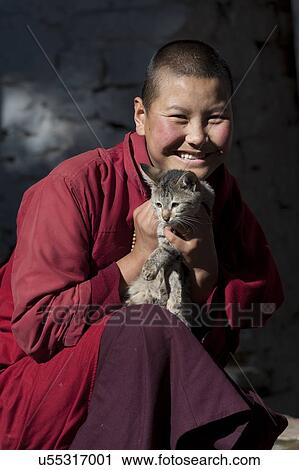 Monk holding a pet cat, Bhutan View Large Photo Image Stock Image - Monk holding a pet cat, Bhutan. Fotosearch