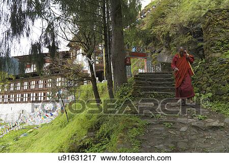 Stock Photo - Monk moving down staircase at Tango Goemba, Thimphu, Bhutan. Fotosearch