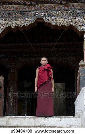 Stock Photo - Monk standing at the entrance of Trongsa Dzong, Trongsa, Bhutan. Fotosearch