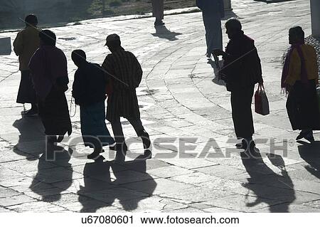 Stock Image - Monks circumambulating at Chorten Kora, National Memorial Chorten, Thimphu, Bhutan. Fotosearch