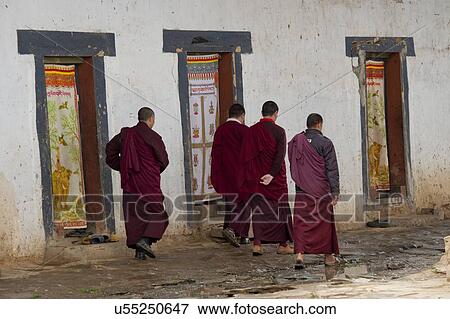 Stock Photo - Monks walking on the street at Gangte Monastery, Gangte Goemba, Phobjikha Valley, Bhutan. Fotosearch