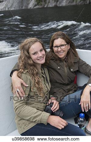 Stock Photo - Mother and daughter enjoying Western Brook Pond fjord boat tour, Gros Morne National Park, Newfoundland and Labrador, Canada. Fotosearch