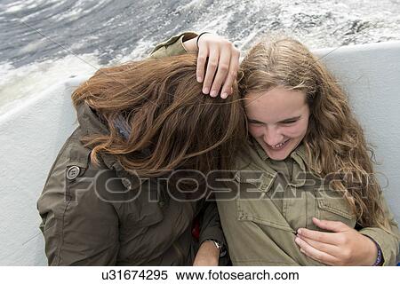 Stock Photography - Mother and daughter enjoying Western Brook Pond fjord boat tour, Gros Morne National Park, Newfoundland and Labrador, Canada. Fotosearch