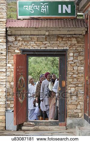 Stock Image - People at entrance gate of National Museum, Paro Valley, Paro District, Bhutan. Fotosearch