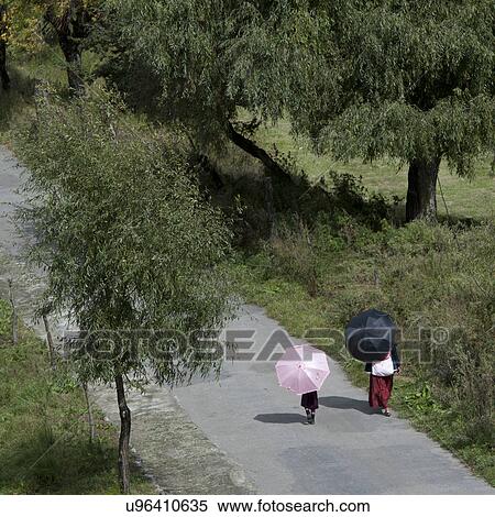People walking along a road in Bumthang District, Chokhor Valley Bhutan View Large Photo Image Stock Photography - People walking along a road in Bumthang District, Chokhor Valley Bhutan. Fotosearch