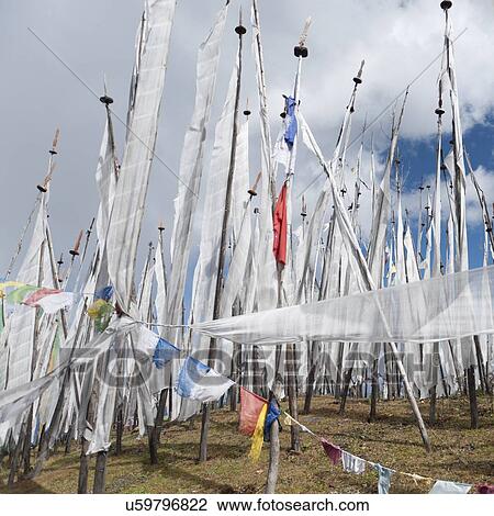 Stock Image - Prayer flags on a mountain, Bhutan. Fotosearch