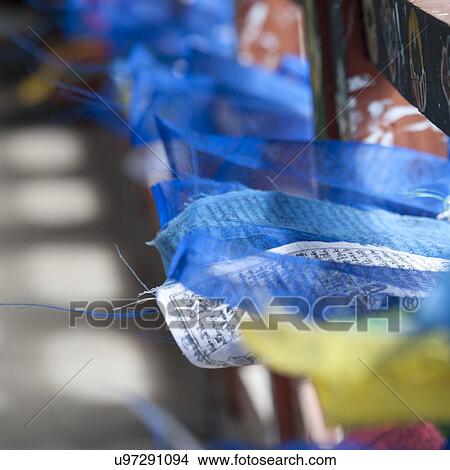 Picture - Prayer flags on display at an outdoor market in Thimphu, Bhutan. Fotosearch