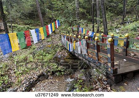 Stock Photo - Prayer flags with a footbridge at Taktsang Monastery, Paro Valley, Paro District, Bhutan. Fotosearch