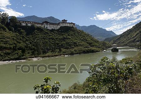 Stock Photo - Puna Tsang Chhu River flowing in front of Wangdue Dzong, Wangdue Phodrang, Bhutan. Fotosearch
