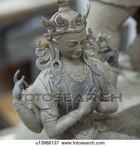 Stock Photo - Statue with four arms at Thirteen Arts and Crafts School in Bhutan. Fotosearch