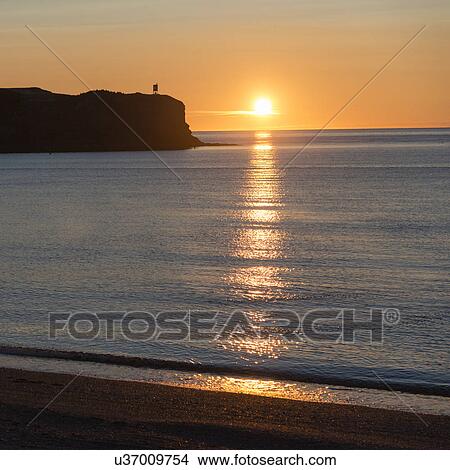 Picture - Sunset on the beach, Trout River, Gros Morne National Park, Newfoundland and Labrador, Canada. Fotosearch