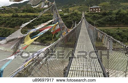 Stock Photo - Suspension bridge across the Puna Tsang River, Punakha District, Bhutan. Fotosearch