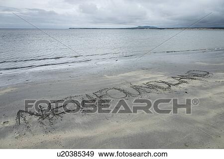 Stock Photo - Text written in sand on beach, Shallow Bay, Gros Morne National Park, Newfoundland and Labrador, Canada. Fotosearch