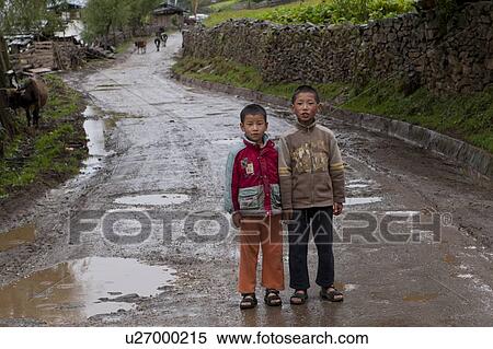 Two children standing on the road, Phobjikha Valley, Bhutan View Large Photo Image Stock Photography - Two children standing on the road, Phobjikha Valley, Bhutan. Fotosearch