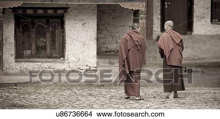 Picture - Two monks in Kharchung Monastery, Chokhor Valley, Bumthang District, Bhutan. Fotosearch
