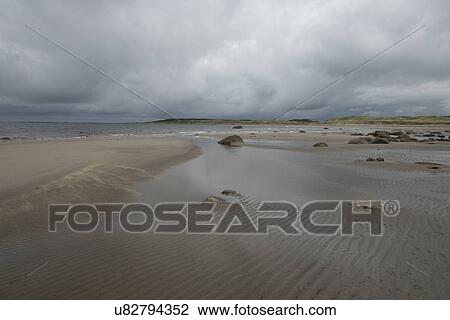 Stock Image - View of a beach, Sally's Cove, Gros Morne National Park, Newfoundland And Labrador, Canada. Fotosearch