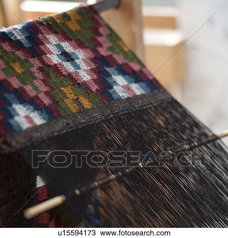 Stock Image - Weaving textiles on a loom in Chhume Valley, Bhutan. Fotosearch