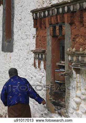 Stock Image - Woman at Jambay Lhakhang, Chokhor Valley, Bumthang District, Bhutan. Fotosearch