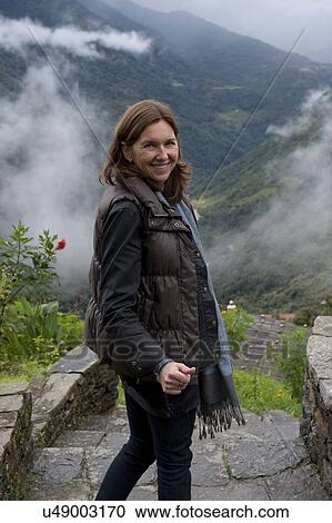 Stock Image - Woman giving thumbs up sign, Trongsa District, Bhutan. Fotosearch