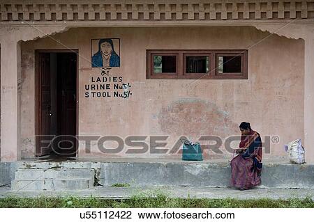 Woman sitting outside a public restroom, Khuruthang, Punakha District, Bhutan View Large Photo Image Stock Image - Woman sitting outside a public restroom, Khuruthang, Punakha District, Bhutan. Fotosearch